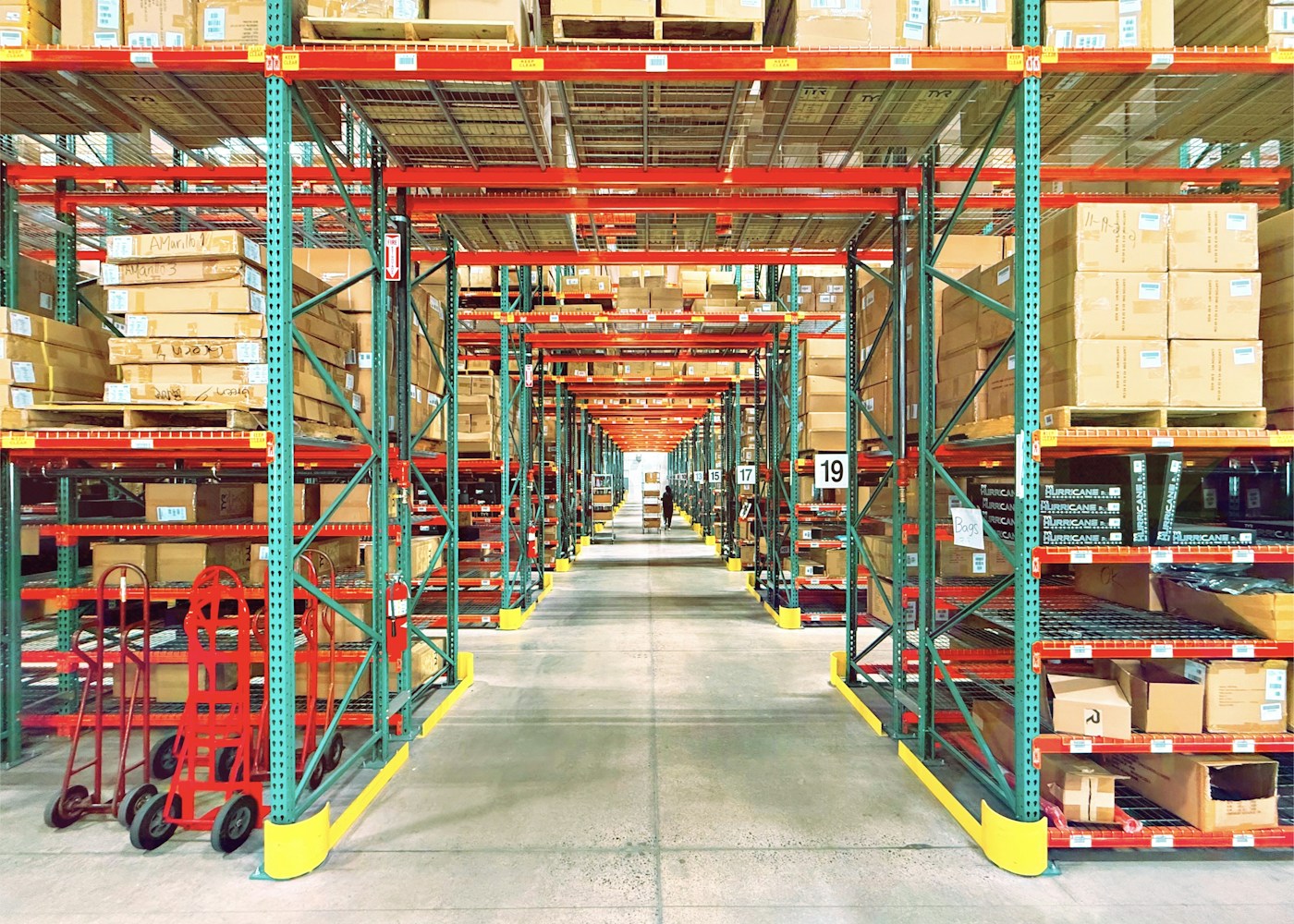 Warehouse aisle with organized storage racks and cartons